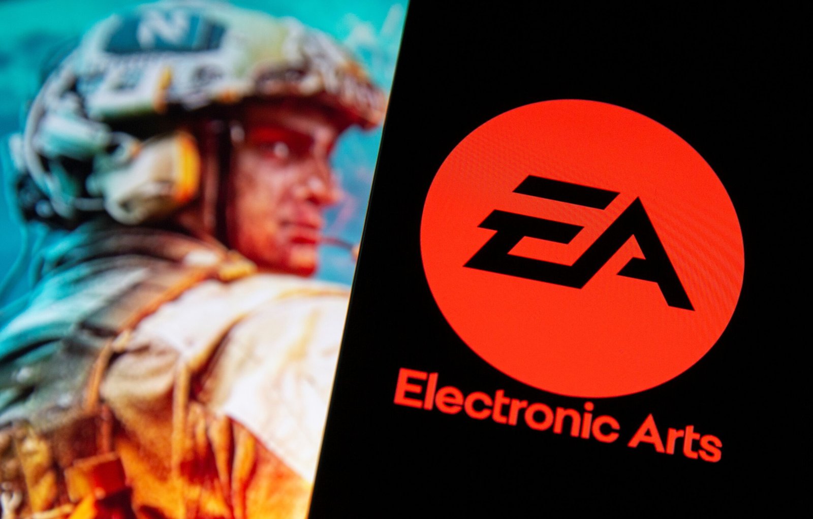 Electronic Arts logo is seen in front of a displayed character from the Battlefield 2042 game in this illustration